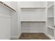 Walk-in closet offers ample storage with wooden rods and shelving over wood-look floor at 2363 W Dusty Wren Dr, Phoenix, AZ 85085
