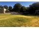 Wide backyard, showing grass, mature trees, truck and trailer, and outbuildings at 25722 S 179Th St, Queen Creek, AZ 85142