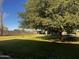 Large backyard featuring well-maintained lawn, mature trees, and animal pens at 25722 S 179Th St, Queen Creek, AZ 85142