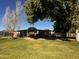 A functional barn structure surrounded by a well-maintained grassy area and mature trees at 25722 S 179Th St, Queen Creek, AZ 85142
