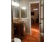 Elegant bathroom boasts a unique vanity with a copper sink, accented by warm lighting and stylish mirrors at 25722 S 179Th St, Queen Creek, AZ 85142