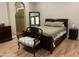 Inviting bedroom showcases a queen bed, hardwood floors, and decorative tile accents at 25722 S 179Th St, Queen Creek, AZ 85142