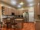 Well-equipped kitchen with granite counters, stainless steel appliances, an island with seating, and modern cabinets at 25722 S 179Th St, Queen Creek, AZ 85142