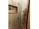 Detailed shower featuring decorative tile accents, a convenient built-in niche, and copper shower fixtures at 25722 S 179Th St, Queen Creek, AZ 85142