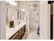 Bathroom featuring double sinks, dark wood cabinets, and a shower/tub combo at 2623 E Indigo Pl, Chandler, AZ 85286