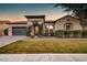 Charming home with manicured lawn, features a decorative iron door and neutral-toned stucco exterior at 2623 E Indigo Pl, Chandler, AZ 85286