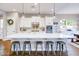 Modern kitchen featuring a large center island, white cabinets, pendant lighting, and stainless steel appliances at 2623 E Indigo Pl, Chandler, AZ 85286