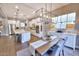 Open-concept kitchen and dining area with a center island, stainless steel appliances, and stylish lighting at 2623 E Indigo Pl, Chandler, AZ 85286