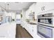 Bright kitchen featuring white cabinets, stainless steel appliances, and hardwood floors at 2623 E Indigo Pl, Chandler, AZ 85286