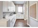 Well-organized pantry featuring white cabinets, quartz countertops, and hardwood floors at 2623 E Indigo Pl, Chandler, AZ 85286