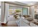 Living room with a sliding door to a patio with a dining table and shade umbrellas at 2623 E Indigo Pl, Chandler, AZ 85286