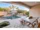 Inviting backyard with a refreshing pool, covered patio, and outdoor dining area at 2623 E Indigo Pl, Chandler, AZ 85286