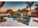 Beautiful backyard pool area with mature trees and ample space for outdoor enjoyment at 2623 E Indigo Pl, Chandler, AZ 85286