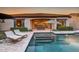 Gorgeous backyard pool with lounge chairs and lush landscaping, perfect for relaxation at 2623 E Indigo Pl, Chandler, AZ 85286