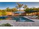Tranquil backyard with swimming pool, outdoor lounge area, and beautiful landscaping at 2623 E Indigo Pl, Chandler, AZ 85286