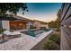 Stunning backyard featuring a sparkling pool, inviting lounge area, and lush greenery at 2623 E Indigo Pl, Chandler, AZ 85286