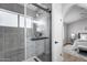 Beautifully renovated bathroom with glass enclosed shower and dark gray tiling at 2730 E Desert Trumpet Rd, Phoenix, AZ 85048