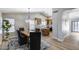 Open-concept dining room with a wooden table and a view of the kitchen featuring an island with bar seating at 2730 E Desert Trumpet Rd, Phoenix, AZ 85048