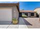 Inviting single-story home featuring desert landscaping and a two-car garage, complemented by a neatly paved walkway to the entrance at 2730 E Desert Trumpet Rd, Phoenix, AZ 85048