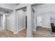 Bright hallway with neutral walls, wood-look flooring, and access to various rooms in the home at 2730 E Desert Trumpet Rd, Phoenix, AZ 85048