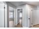 Hallway showcasing doors to different bedrooms and closet with neutral walls at 2730 E Desert Trumpet Rd, Phoenix, AZ 85048