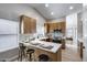 Bright kitchen featuring wood cabinets, stainless steel appliances, and a sleek white countertop with bar stool seating at 2730 E Desert Trumpet Rd, Phoenix, AZ 85048