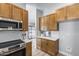 Well-equipped kitchen featuring wood cabinets, stainless steel appliances, and access to the outdoor area at 2730 E Desert Trumpet Rd, Phoenix, AZ 85048