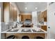 Modern kitchen with white countertops, light wood cabinetry, and stainless steel appliances, perfect for cooking and entertaining at 2730 E Desert Trumpet Rd, Phoenix, AZ 85048