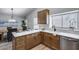 Modern kitchen with wood cabinets, sleek countertops, stainless steel appliances, and an adjacent dining area at 2730 E Desert Trumpet Rd, Phoenix, AZ 85048