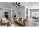 Open living room with neutral walls, leather couch, modern ceiling fan and views to the entry way at 2730 E Desert Trumpet Rd, Phoenix, AZ 85048