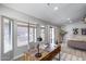 Sunlit home office with a rustic wooden desk and views of the backyard at 2730 E Desert Trumpet Rd, Phoenix, AZ 85048
