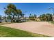 Community sand volleyball court surrounded by grass, trees, and mountain views at 2730 E Desert Trumpet Rd, Phoenix, AZ 85048