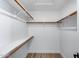 Spacious walk-in closet featuring clean white walls, shelving and new laminate floors at 2730 E Desert Trumpet Rd, Phoenix, AZ 85048