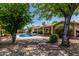 A refreshing private pool nestled in lush green backyard with mature trees and flagstone patio at 3030 S Rogers --, Mesa, AZ 85202