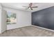 Bright bedroom featuring a ceiling fan, natural light, and neutral carpet, creating a serene atmosphere at 3030 S Rogers --, Mesa, AZ 85202