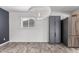 Dining area with modern light fixture, grey accent wall, new floors, and stainless steel appliances at 3030 S Rogers --, Mesa, AZ 85202