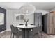 Contemporary dining room featuring stylish lighting, seating for six, and stainless steel refrigerator at 3030 S Rogers --, Mesa, AZ 85202
