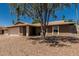 Desert landscaping surrounds the home with a covered entrance, and neutral colors on the exterior at 3030 S Rogers --, Mesa, AZ 85202