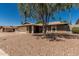 Desert landscaping surrounds the home with a covered entrance, and neutral colors on the exterior at 3030 S Rogers --, Mesa, AZ 85202