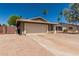 Home with neutral desert colors, desert landscaping, and front two-car garage at 3030 S Rogers --, Mesa, AZ 85202