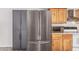 Stainless steel refrigerator perfectly situated next to wood cabinets, enhancing the kitchen's functionality and style at 3030 S Rogers --, Mesa, AZ 85202