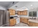Well-lit kitchen featuring stainless steel appliances, wood cabinetry, and breakfast bar at 3030 S Rogers --, Mesa, AZ 85202