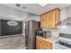 Kitchen showcases stainless steel appliances, wood cabinets, and seamless flow to dining area at 3030 S Rogers --, Mesa, AZ 85202