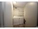 Bright laundry area with open wire shelving and front loading washer and dryer at 3030 S Rogers --, Mesa, AZ 85202