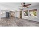 Spacious living room showcasing new flooring, a modern ceiling fan, and natural light at 3030 S Rogers --, Mesa, AZ 85202