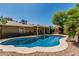 A sparkling pool with lush surroundings, next to the home's exterior with covered patio at 3030 S Rogers --, Mesa, AZ 85202