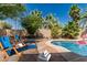 Inviting pool with lounge chairs and lush desert landscaping offers a relaxing outdoor retreat at 3030 S Rogers --, Mesa, AZ 85202