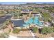 Aerial view of the community center with multiple pools, sunshades, palm trees, and seating areas at 3128 E Tina Dr, Phoenix, AZ 85050