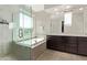 Elegant bathroom with a glass-enclosed shower, soaking tub, and modern fixtures at 3128 E Tina Dr, Phoenix, AZ 85050