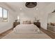 Well-lit bedroom features hardwood floors, a large bed, and stylish bedside tables at 3128 E Tina Dr, Phoenix, AZ 85050